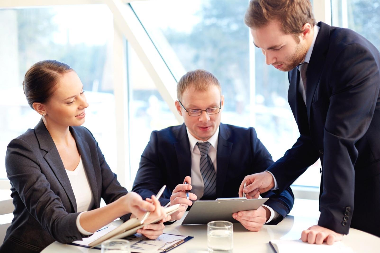 Modern office workspace with organized budget approval workflow materials and collaborative meeting setup